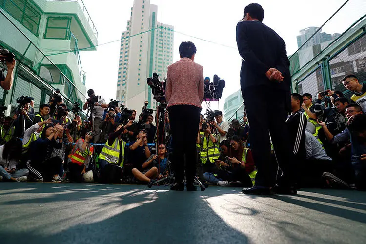 Hong Kong Chief Executive Carrie Lam speaks to the media after casting her vote at a polling station during district council local elections in Hong Kong on November 24, 2019. (Reuters/Thomas Peter)