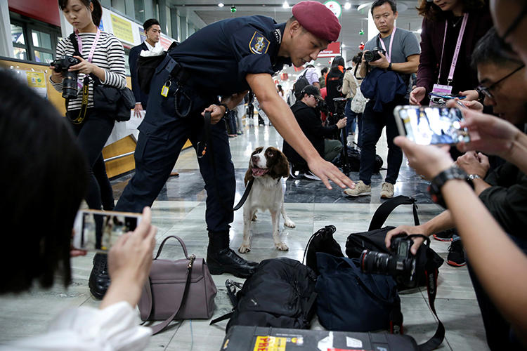 A security officer checks journalists' belongings at Macau International Airport on December 18, 2019. At least three journalists were recently denied entry into the territory. (Reuters/Jason Lee)
