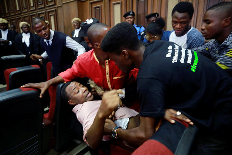 Fighting breaks out as security personnel attempt to re-arrest Nigerian activist and journalist Omoyele Sowore at the Federal High Court in Abuja, Nigeria, on December 6, 2019. Sowore and other activist-journalists have been jailed in Nigeria and Ethiopia amid a crackdown on free expression. (Reuters/Afolabi Sotunde)