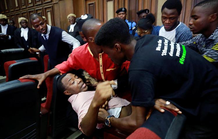 Fighting breaks out as security personnel attempt to re-arrest Nigerian activist and journalist Omoyele Sowore at the Federal High Court in Abuja, Nigeria, on December 6, 2019. Sowore and other activist-journalists have been jailed in Nigeria and Ethiopia amid a crackdown on free expression. (Reuters/Afolabi Sotunde)