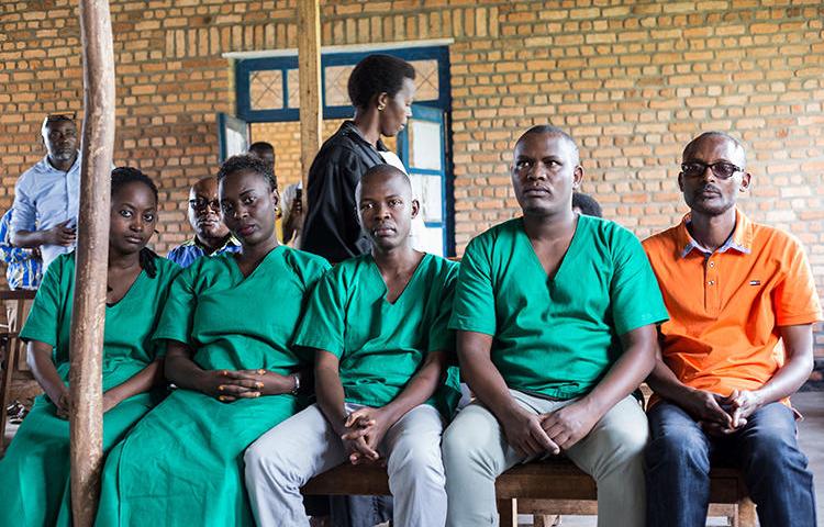 Four journalists from Burundian news outlet Iwacu (from left) Agnes Ndirubusa, Christine Kamikazi, Terence Mpozenzi, and Egide Harerimana--and their driver Adolphe Masabarakiza--appear at the High Court in Bubanza, western Burundi, on December 30, 2019, charged with undermining state security. (AFP/Tchandrou Nitanga)