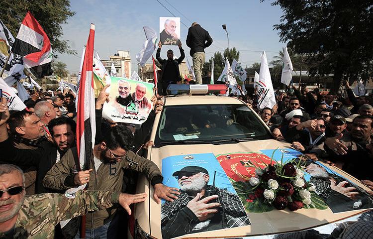 Mourners surround a car carrying the coffin of Iraqi paramilitary chief Abu Mahdi al-Muhandis in Baghdad on January 4, 2020. (AFP/Ahmad Al-Rubaye)