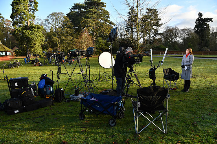Members of the media prepare a broadcast report outside Sandringham Estate, the private residence of Britain's Queen Elizabeth II, in eastern England, on January 13, 2020. A plan by Duke and Duchess of Sussex to change the rules of media engagement raised issues of access and what constitutes “credible media” in the United Kingdom this week. (AFP/Ben Stansall)