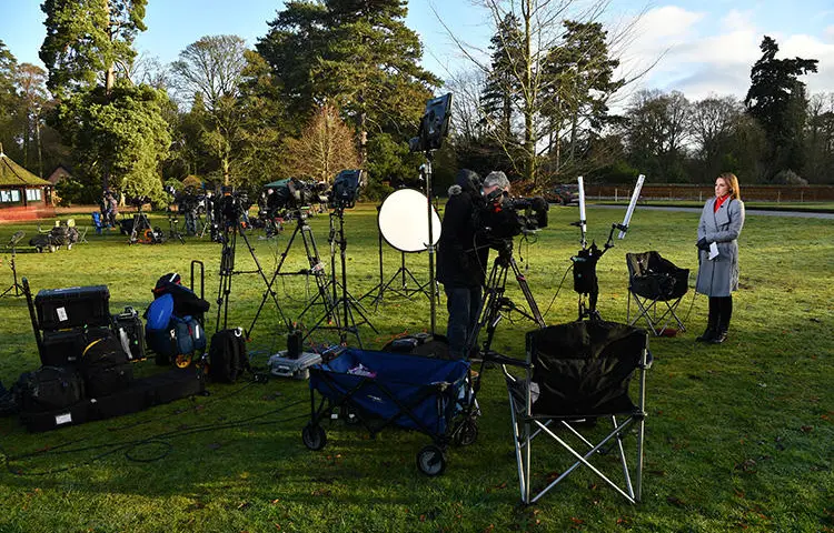 Members of the media prepare a broadcast report outside Sandringham Estate, the private residence of Britain's Queen Elizabeth II, in eastern England, on January 13, 2020. A plan by Duke and Duchess of Sussex to change the rules of media engagement raised issues of access and what constitutes “credible media” in the United Kingdom this week. (AFP/Ben Stansall)