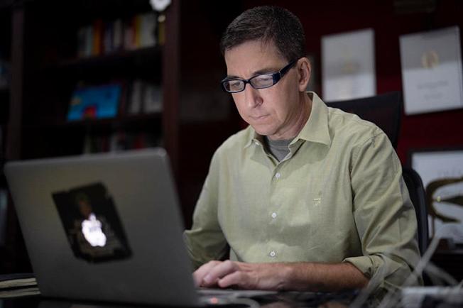 In a July 10, 2019, photo, journalist Glenn Greenwald is shown at his home in Rio de Janeiro, Brazil. Brazil's federal public prosecutor on January 21, 2020, charged Greenwald with crimes including criminal association and invasion of an electronic device in connection with a series of reports published in The Intercept Brasil in June 2019. (AP Photo/Leo Correa)