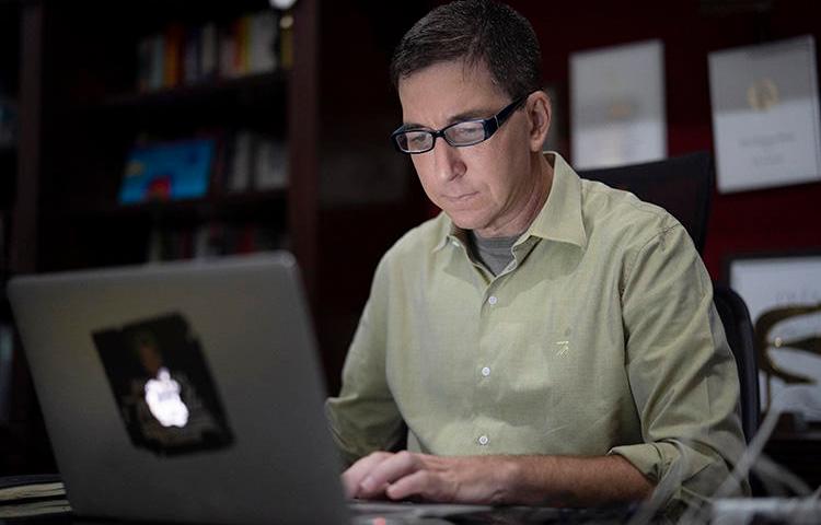 In a July 10, 2019, photo, journalist Glenn Greenwald is shown at his home in Rio de Janeiro, Brazil. Brazil's federal public prosecutor on January 21, 2020, charged Greenwald with crimes including criminal association and invasion of an electronic device in connection with a series of reports published in The Intercept Brasil in June 2019. (AP Photo/Leo Correa)