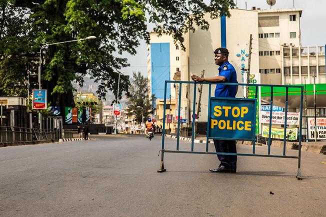 A police officer is seen in Freetown, Sierra Leone, on March 27, 2015. Journalists covering a local politician were recently attacked in two separate incidents in Sierra Leone. (AP/Michael Duff)