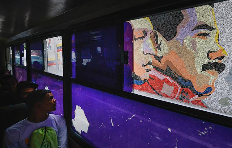 A mosaic of late leader Hugo Chavez and President Nicolas Maduro is seen in Caracas, Venezuela, on December 19, 2019. Venezuelan authorities recently released freelance photojournalist Jesús Medina after 16 months of detention. (AP/Matias Delacroix)
