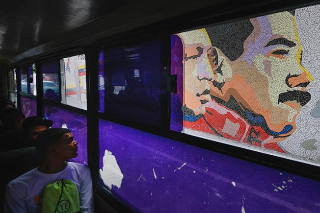 A mosaic of late leader Hugo Chavez and President Nicolas Maduro is seen in Caracas, Venezuela, on December 19, 2019. Venezuelan authorities recently released freelance photojournalist Jesús Medina after 16 months of detention. (AP/Matias Delacroix)