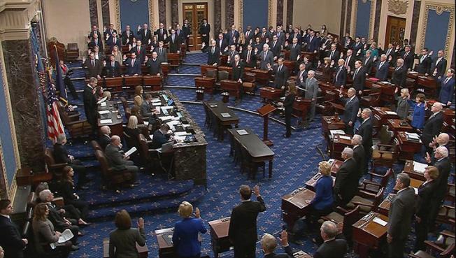 Chief Justice of the United States John Roberts swears in senators during the procedural start of the Senate impeachment trial of U.S. President Donald Trump in this frame grab from video shot in the Senate Chamber at the U.S. Capitol in Washington, D.C., on January 16, 2020. CPJ and 57 news organizations asked the Senate to rethink press restrictions during the impeachment trial. (Reuters/U.S. Senate TV/Handout via Reuters)