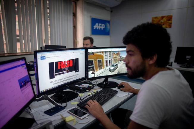 An AFP fact-checking team journalist works at Agence France-Presse Bureau in Rio de Janeiro, Brazil, on September 27, 2018. On February 11, 2020, Brazilian journalist Patrícia Campos Mello faced online harassment campaign after allegations made during a congressional hearing on fake news. (AFP/Maruo Pimentel)