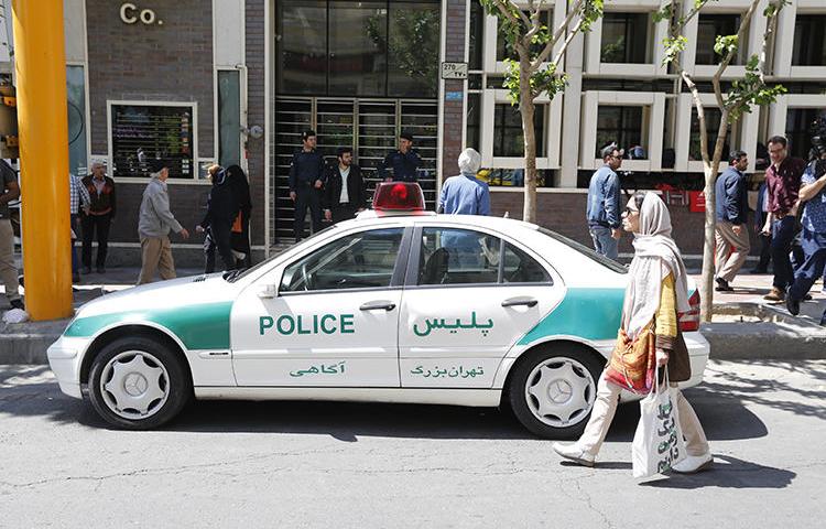 An Iranian police vehicle is seen in Tehran on April 10, 2018. Iranian authorities recently convicted three editors on defamation and false news charges. (AFP/Atta Kenare)