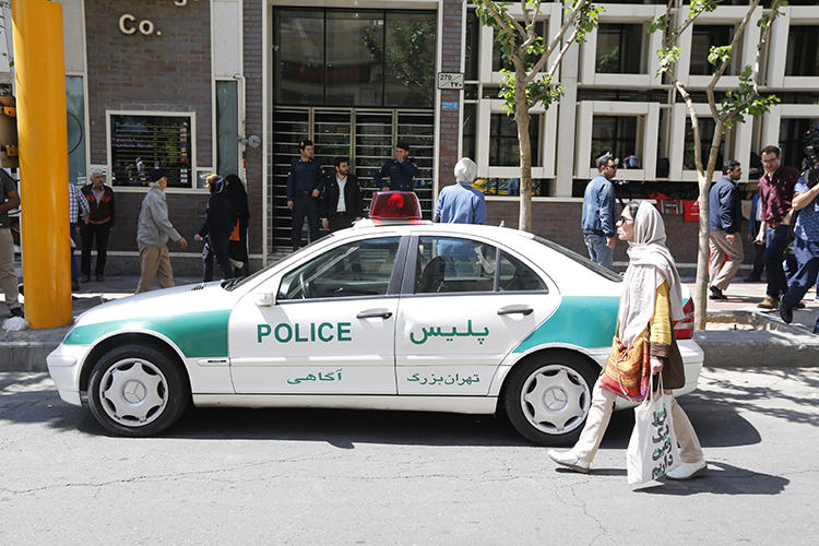 An Iranian police vehicle is seen in Tehran on April 10, 2018. Iranian authorities recently convicted three editors on defamation and false news charges. (AFP/Atta Kenare)