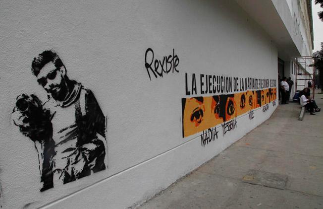 Graffiti shows the likeness of murdered photojournalist Rubén Espinosa and the eyes and names of the other four victims, on the wall of Mexico City attorney general's headquarters in Mexico City, in July 2016. Deadly violence against journalists is rare in the capital, but reporters covering organized crime in the city say threats are on the rise. (AP/Marco Ugarte)