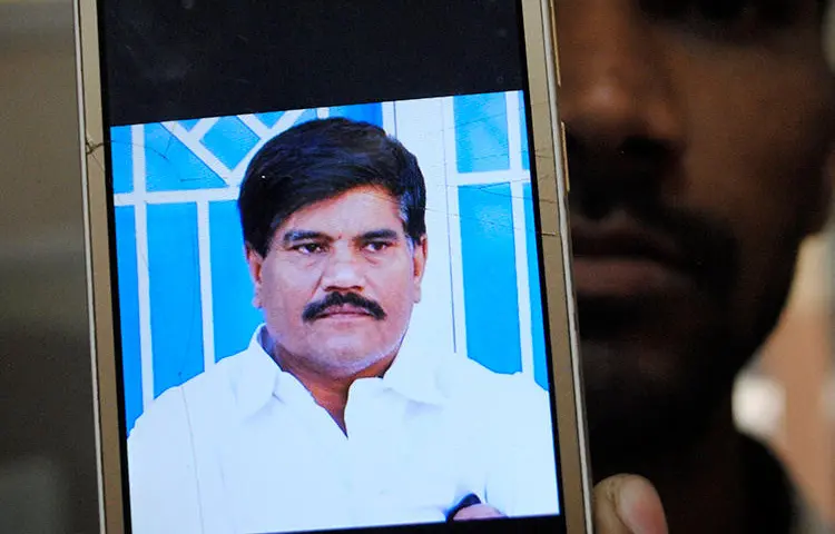 An employee of a local television channel shows a picture of slain journalist Aziz Memon on his mobile, after a demonstration to condemn his killing, in Hyderabad, Pakistan, Monday, Feb. 17, 2020. The body of Memon was found dumped in a canal just hours after he went missing while on his way to work, police said Monday. His family said he was brutally killed but that they have no idea who was behind the slaying. (AP/Pervez Masih)