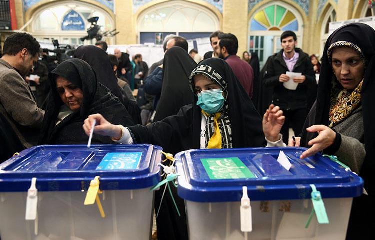 A woman wears a face mask as she casts her vote during parliamentary elections at a polling station in Tehran, Iran February 21, 2020. Iranian authorities detained journalist Mohammad Mosaed the next day for his social media posts. (Nazanin Tabatabaee/West Asia News Agency via Reuters)