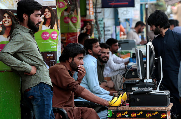 People using computers are seen in Islamabad, Pakistan, on October 20, 2017. The country secretly passed regulations that restrict social media activity. (Reuters/Caren Firouz)