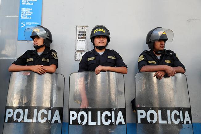 Police officers are seen in Lima, Peru, on March 19, 2019. Journalist Jimmy Alejandro Castillo Gamarra was recently assaulted in the town of San Marcos, in northern Peru. (Reuters/Guadalupe Pardo)