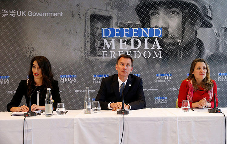 Human rights lawyer Amal Clooney, British then-Foreign Secretary Jeremy Hunt, and Canadian then-Foreign Minister Chrystia Freeland address a news conference on media freedom in Dinard, France on April 5, 2019. A panel of legal experts led by Clooney recommend more sanctions targeted at press freedom violators. (Reuters/Stephane Mahe)