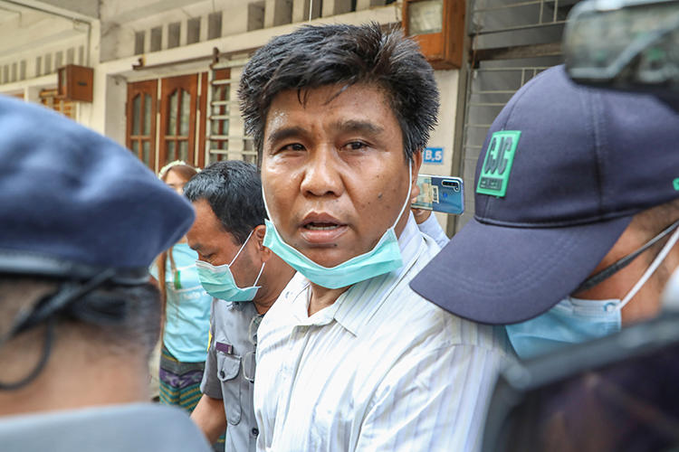Voice of Myanmar editor-in-chief Ko Nay Lin is escorted by police to court in Mandalay, Myanmar, on March 31, 2020. He is facing life in prison on terrorism charges for his reporting. (AFP/Zaw Zaw)