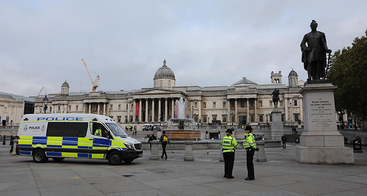Police officers are seen around Trafalgar Square in London on October 15, 2019. A U.K. agency recently released a report detailing surveillance efforts involving journalists. (AFP/Isabel Infantes)