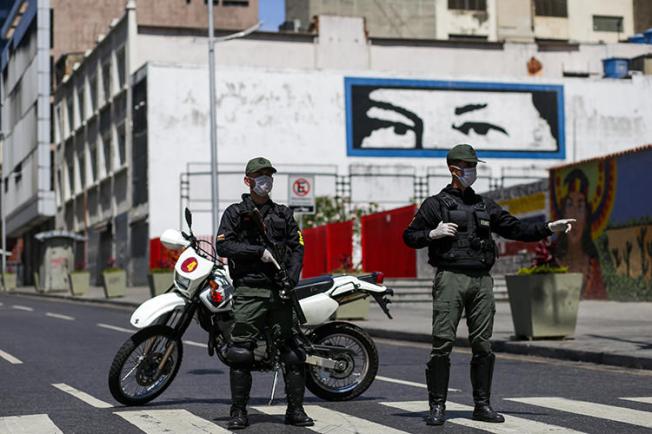 Members of the Bolivarian National Guard wearing face masks are seen in Caracas, Venezuela, on March 17, 2020. Journalists have recently been harassed and detained over their reporting on the virus. (AFP/Cristian Hernandez)