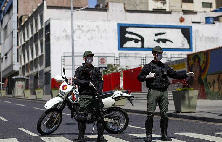 Members of the Bolivarian National Guard wearing face masks are seen in Caracas, Venezuela, on March 17, 2020. Journalists have recently been harassed and detained over their reporting on the virus. (AFP/Cristian Hernandez)