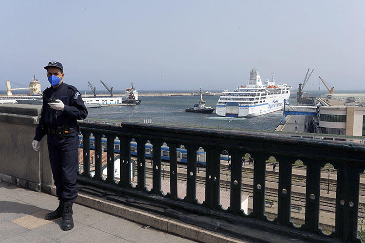 A police officer is seen in Algiers, Algeria, on March 19, 2020. Algerian authorities recently imprisoned journalist and RSF correspondent Khaled Drareni. (AP/Toufik Doudou)