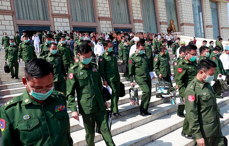 Military representatives are seen in Naypyitaw, Myanmar, on March 10, 2020. The Myanmar military is suing Ye Ni, Burmese-language editor of the independent news website The Irrawaddy, for criminal defamation. (AP/Aung Shine Oo)