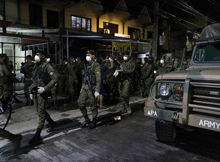 Soldiers are seen in Manila, the Philippines, on March 15, 2020. The country's state of emergency includes a regulation imposing criminal penalties for spreading ‘false news’ about the coronavirus pandemic. (AP/Aaron Favila)