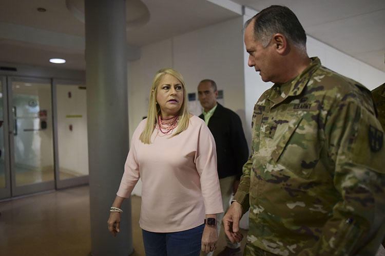Governor Wanda Vazquez and National Guard general Jose Reyes tour screening stations established to detect the new coronavirus on arriving passengers at the Luis MuÃ±oz Marin Airport in Carolina, Puerto Rico, on March 16, 2020. Reporter Bárbara Figueroa Rosa described the challenges of covering Puerto Rico’s coronavirus outbreak. (AP Photo/Carlos Giusti)