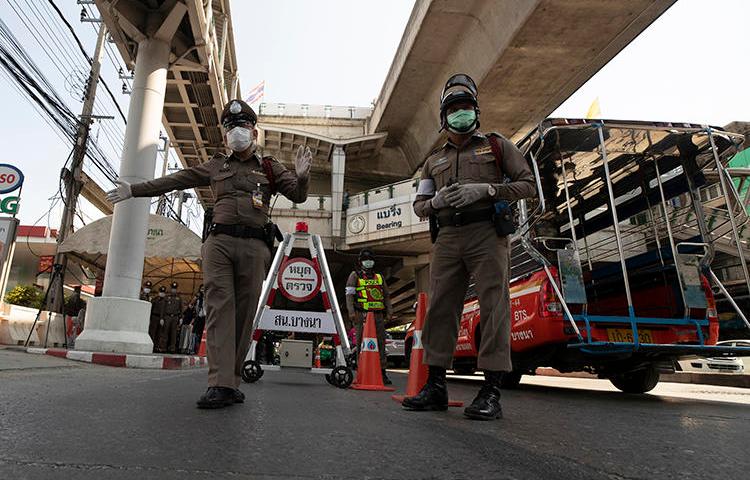 Police officers are seen in Bangkok, Thailand, on March 26, 2020. The Thai government has imposed a state of emergency in response to the COVID-19 outbreak, and has restricted the press. (AP/Sakchai Lalit)
