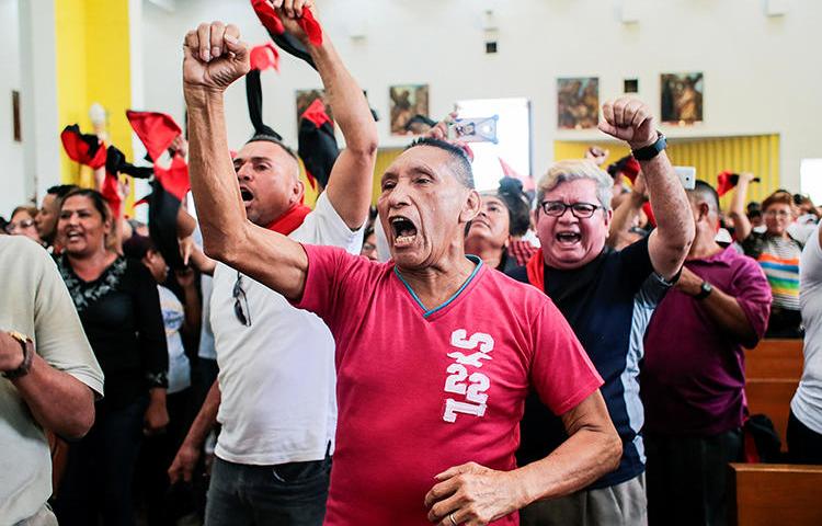 Supporters of Nicaraguan President Daniel Ortega shout slogans at the Metropolitan Cathedral in Managua, Nicaragua, on March 3, 2020. Government supporters attacked several journalists covering a funeral at the church. (Reuters/Oswaldo Rivas)