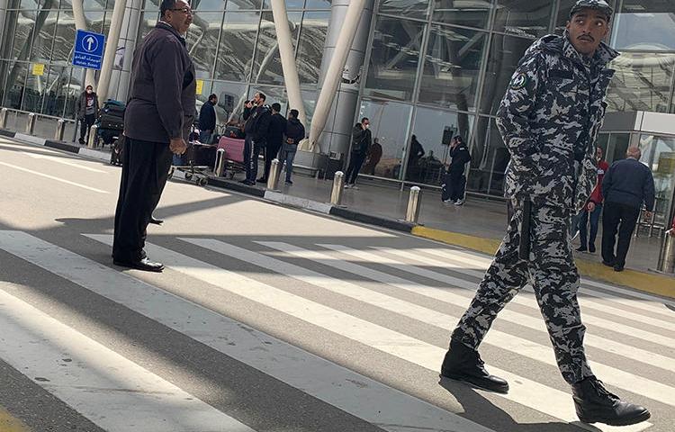 A police officer is seen at Cairo International Airport in Cairo, Egypt, on March 19, 2020. Egypt recently expelled Guardian reporter Ruth Michaelson over her reporting on the COVID-19 outbreak. (Reuters/Amr Abdallah Dalsh)
