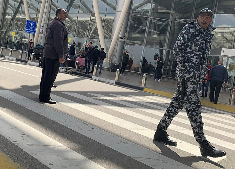 A police officer is seen at Cairo International Airport in Cairo, Egypt, on March 19, 2020. Egypt recently expelled Guardian reporter Ruth Michaelson over her reporting on the COVID-19 outbreak. (Reuters/Amr Abdallah Dalsh)