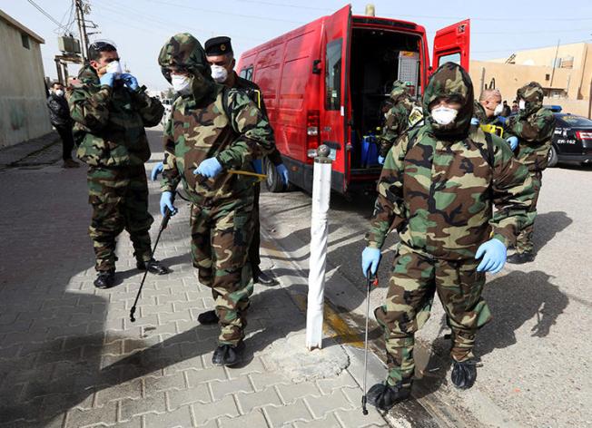 Members of a civil defense team disinfect the homes of people infected with coronavirus in Kirkuk, Iraq, on February 26, 2020. Security officers in Kurkuk recently confiscated the belongings of journalist Azad Shakur for allegedly violating a COVID-19 curfew. (Reuters/Ako Rasheed)