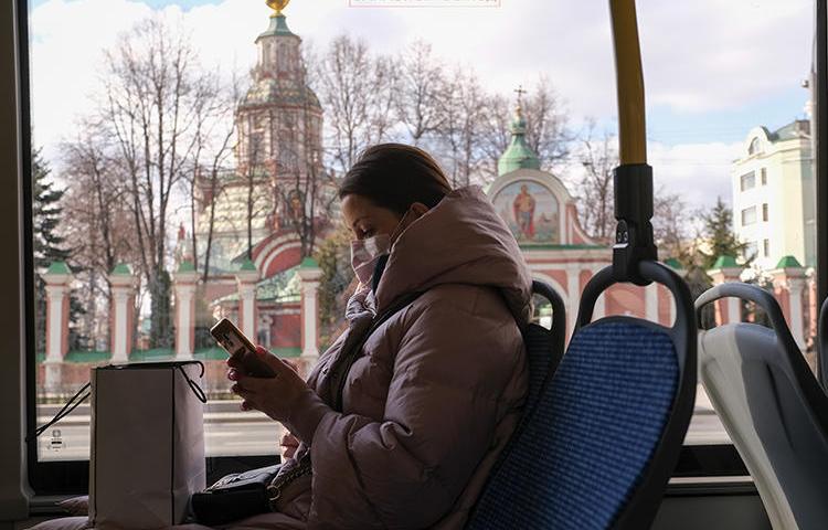 Девушка в маске едет в московском автобусе 23 марта 2020 г. Роскомнадзор принял карательные меры в отношении двух СМИ из-за репортажей о COVID-19 (Рейтер/Евгения Новоженина)