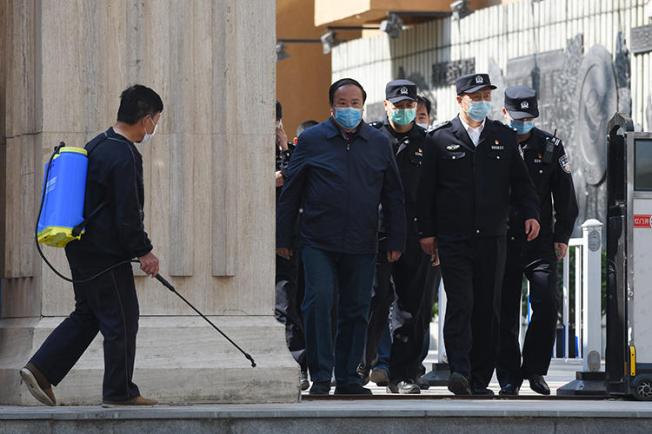 Police are seen in Beijing, China, on April 27, 2020. Police recently arrested two media workers in Beijing, and a third is missing. (AFP/Greg Baker)