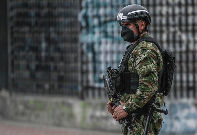 A police officer patrols the streets in Bogota, Colombia, on March 25, 2020. Colombian journalist Eder Narváez Sierra recently received death threats over his reporting. (AFP/Juan Barreto)