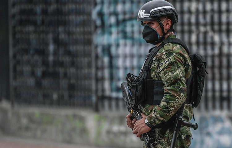 A police officer patrols the streets in Bogota, Colombia, on March 25, 2020. Colombian journalist Eder Narváez Sierra recently received death threats over his reporting. (AFP/Juan Barreto)