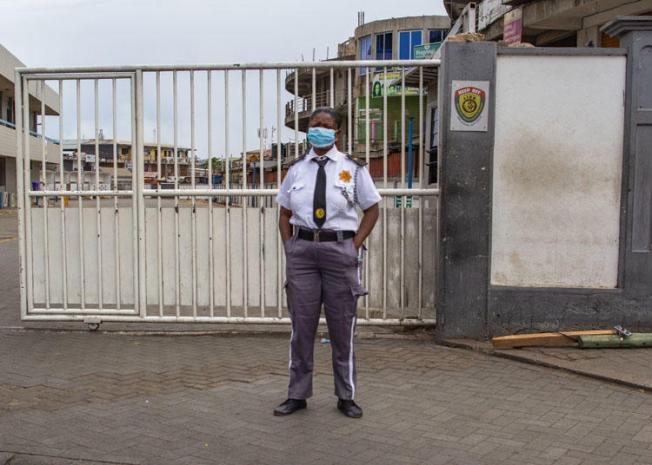 A security guard wears a mask as a protective measure against COVID-19 disease in Accra, Ghana, on April 4, 2020. Soldiers enforcing restrictions related to the pandemic assaulted journalists in two separate incidents. (Nipah Dennis/AFP)