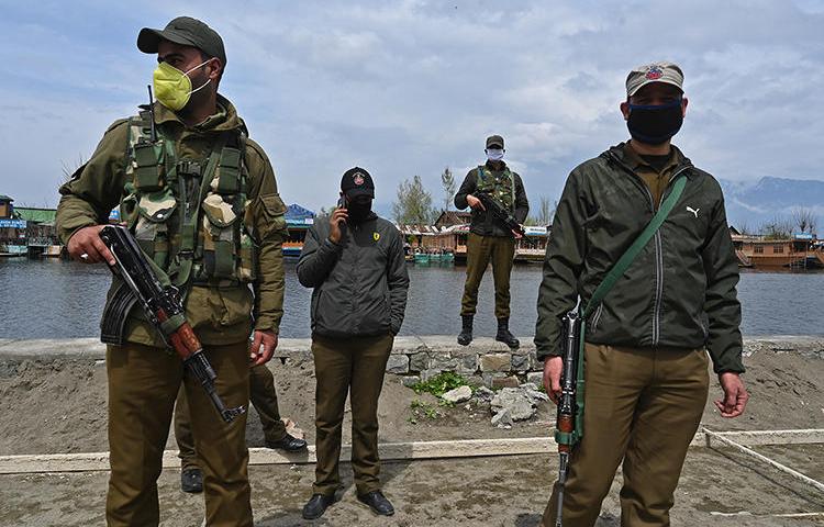Police officers are seen Srinagar, Indian-controlled Jammu and Kashmir state, on March 31, 2020. Jammu and Kashmir police recently launched an investigation into journalist Gowhar Geelani. (AFP/Tauseef Mustafa)