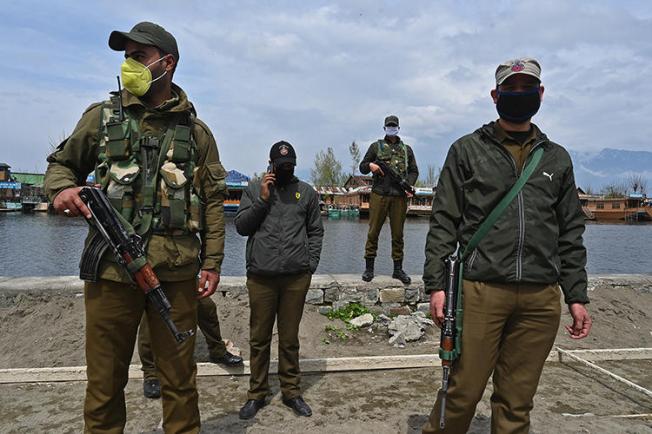 Police officers are seen Srinagar, Indian-controlled Jammu and Kashmir state, on March 31, 2020. Jammu and Kashmir police recently launched an investigation into journalist Gowhar Geelani. (AFP/Tauseef Mustafa)