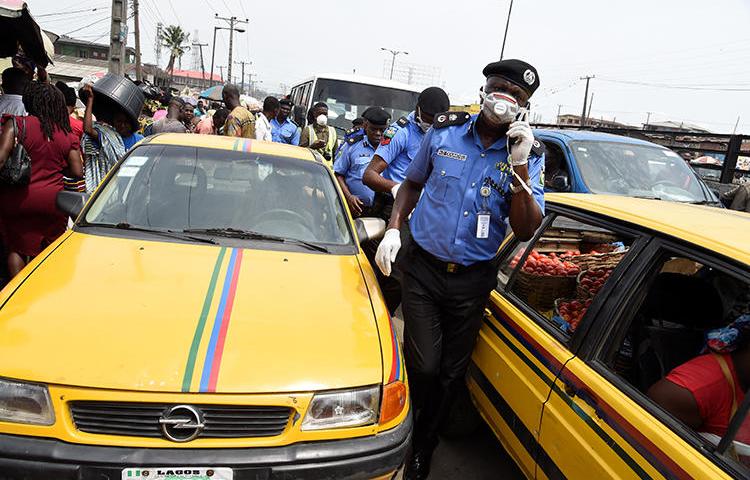 A police officer is seen in Lagos, Nigeria, on March 26, 2020. Police recently arrested two journalists for their work in Ebonyi state. (AFP/Pius Utomi Ekpei)