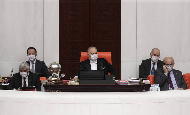 Turkey's Deputy Parliament Speaker Levent Gok (center) is seen in the Parliament in Ankara on April 7, 2020. The Turkish parliament is considering an amnesty bill that would release 90,000 prisoners, but not include journalists. (AFP/Adem Altan)