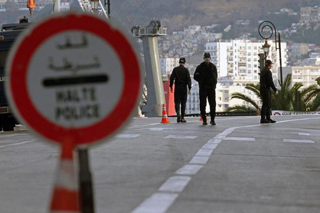 Security forces are seen in Algiers, Algeria, on April 8, 2020. Algerian authorities recently blocked three news websites in the country and passed legislation criminalizing "fake news." (AP/Toufik Doudou)