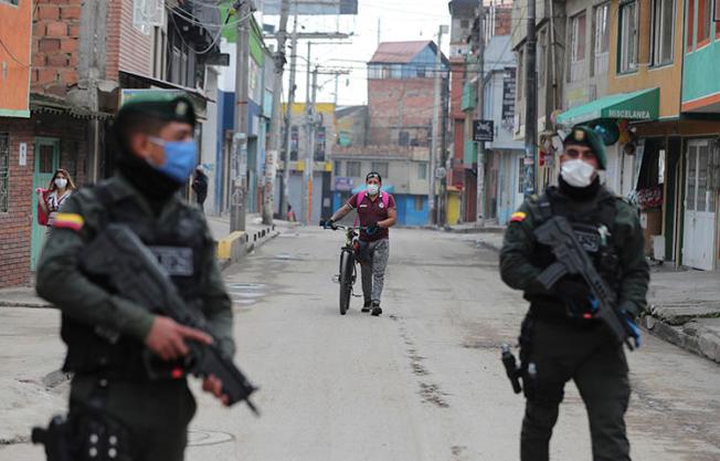 Police are seen in Bogota, Colombia, on March 25, 2020. Authorities recently suspended meetings of the country's journalist protection program amid fears of the COVID-19 pandemic. (AP/Fernando Vergara)