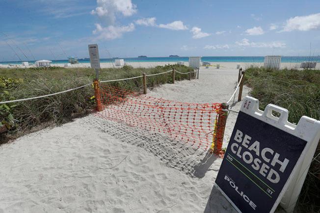 An entrance to a beach is closed on March 31, 2020, in Miami Beach, Florida. (AP Photo/Wilfredo Lee)