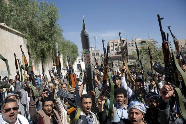 Tribesmen loyal to the Houthi rebel group raise their weapons as they chant slogans during a gathering aimed at mobilizing more fighters for the Houthi movement in Sanaa, Yemen, on February 25, 2020. The Houthis sentenced four journalists in their custody to death on April 11, 2020. (AP Photo/Hani Mohammed)