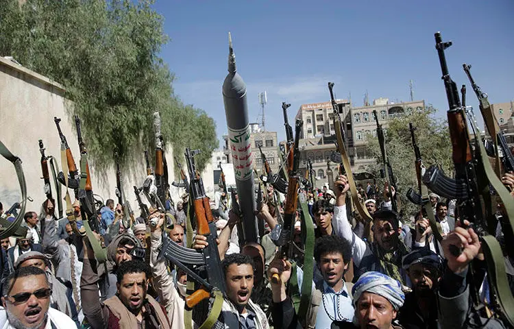 Tribesmen loyal to the Houthi rebel group raise their weapons as they chant slogans during a gathering aimed at mobilizing more fighters for the Houthi movement in Sanaa, Yemen, on February 25, 2020. The Houthis sentenced four journalists in their custody to death on April 11, 2020. (AP Photo/Hani Mohammed)